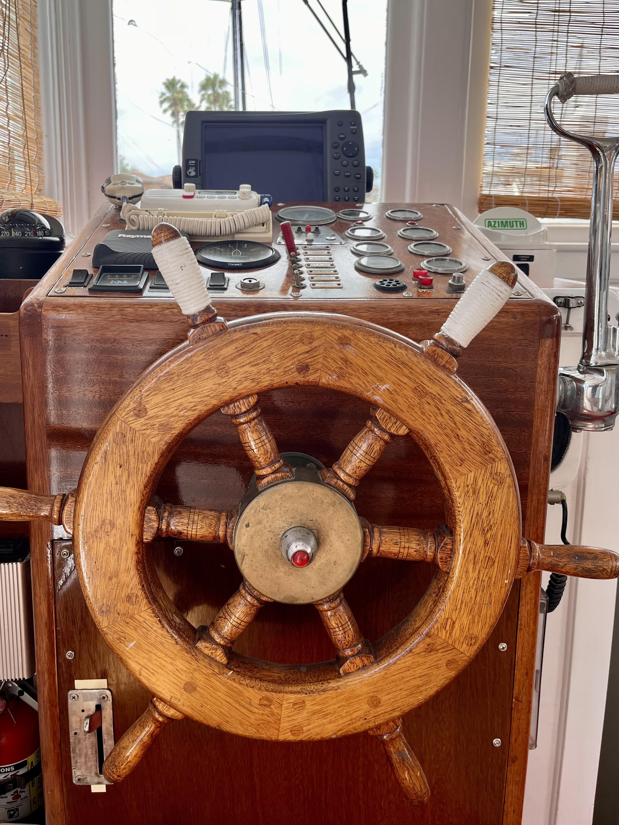 The traditional wooden ship's wheel.